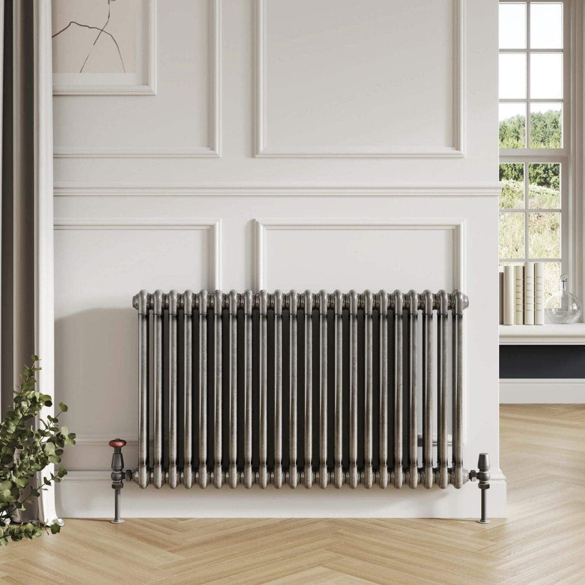Polished metal radiator in a modern bathroom with white wall paneling and natural light.