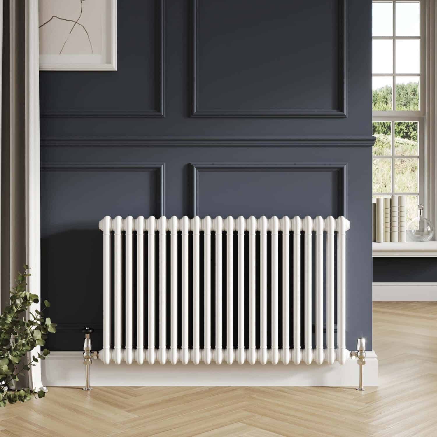 Radiator in a modern bathroom with dark navy wall panels and light wooden flooring, complemented by decorative wall art and window view, showcasing stylish heating solutions.