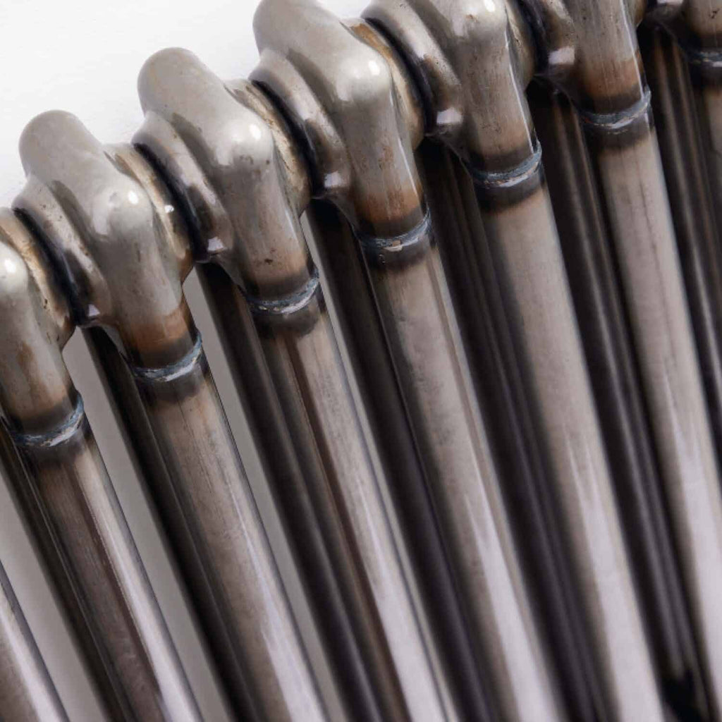 Rustic central heating radiator in a modern bathroom setting, showcasing durable metal design suitable for bathroom heating solutions and adding a vintage touch to bathroom decor.