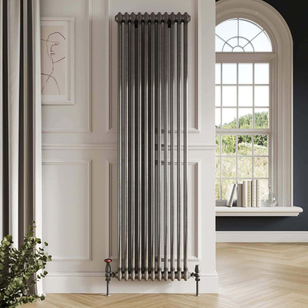 Chrome vertical modern radiator in a stylish bathroom with elegant interior design and large window, perfect for contemporary home heating solutions.