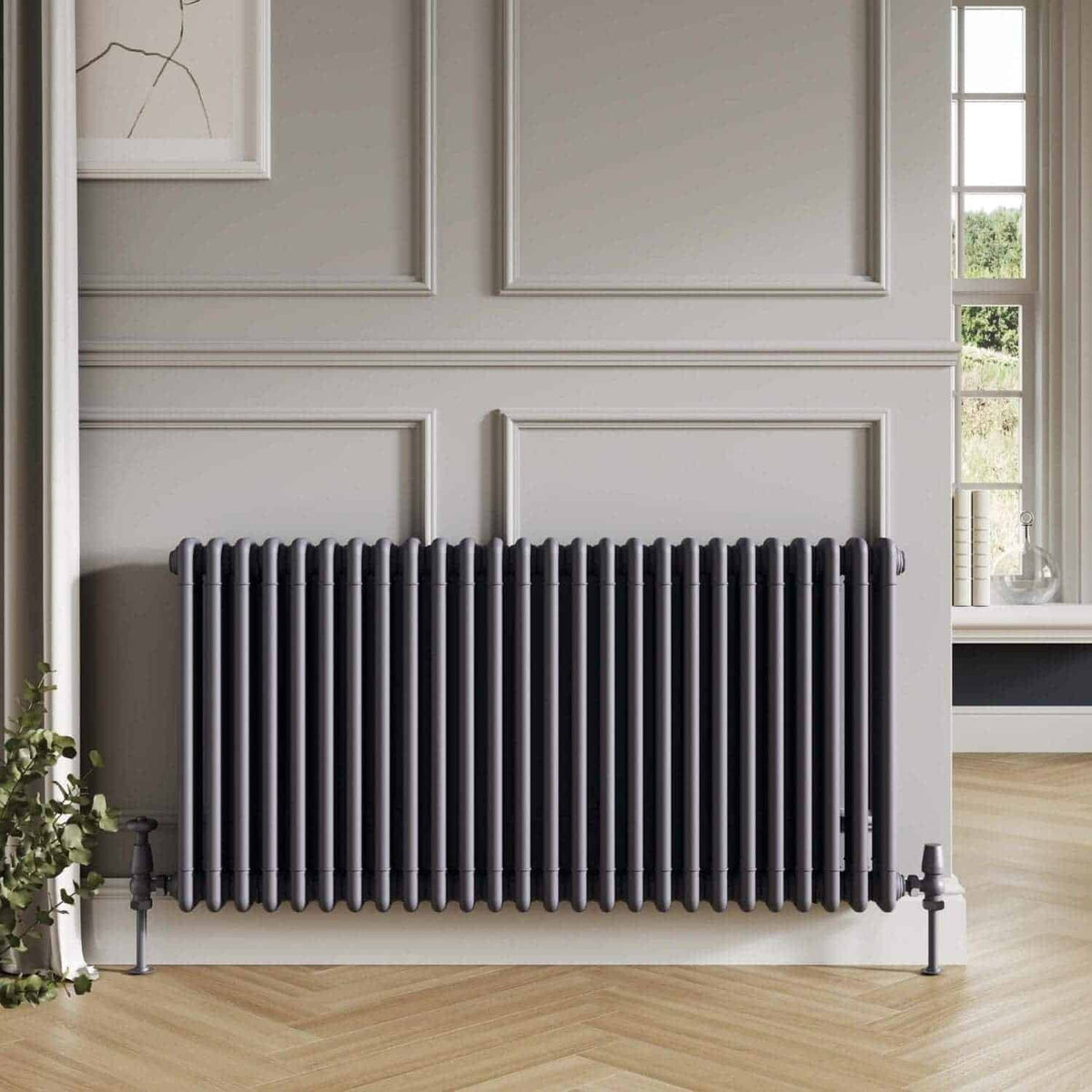 Sleek black radiator in modern bathroom with interior wall paneling and large window, creating a stylish and functional heating solution for contemporary home spaces.