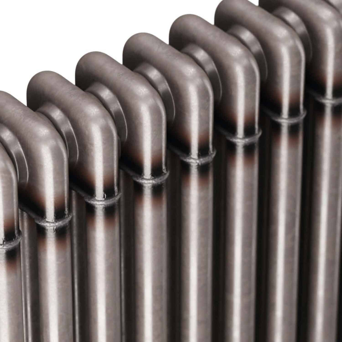 Shiny metallic radiator, close-up view showing the smooth, curved pipes and modern design, ideal for heating solutions in contemporary bathrooms and homes.