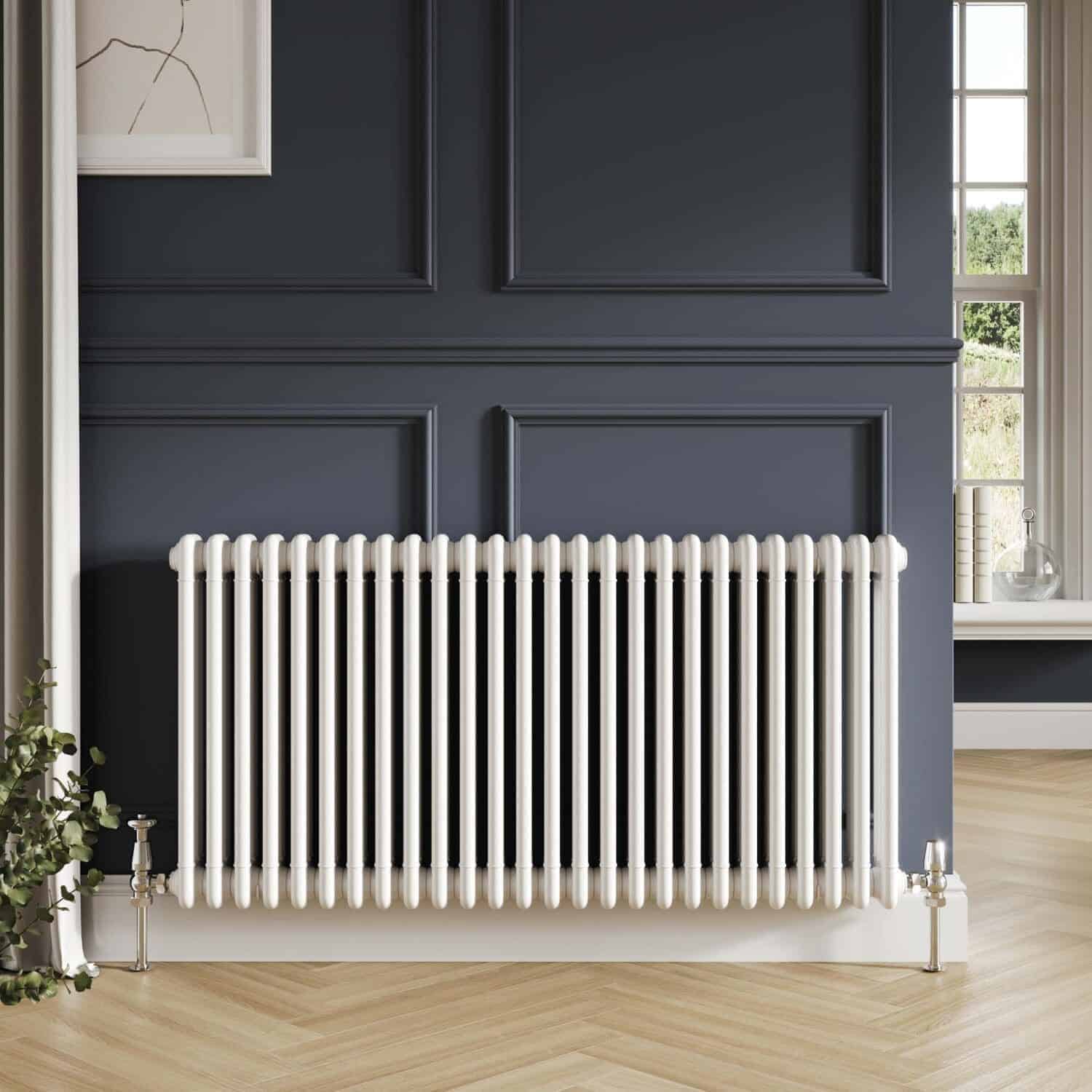 Vintage white radiator in a stylish modern bathroom with dark navy wall paneling and natural light from a window.