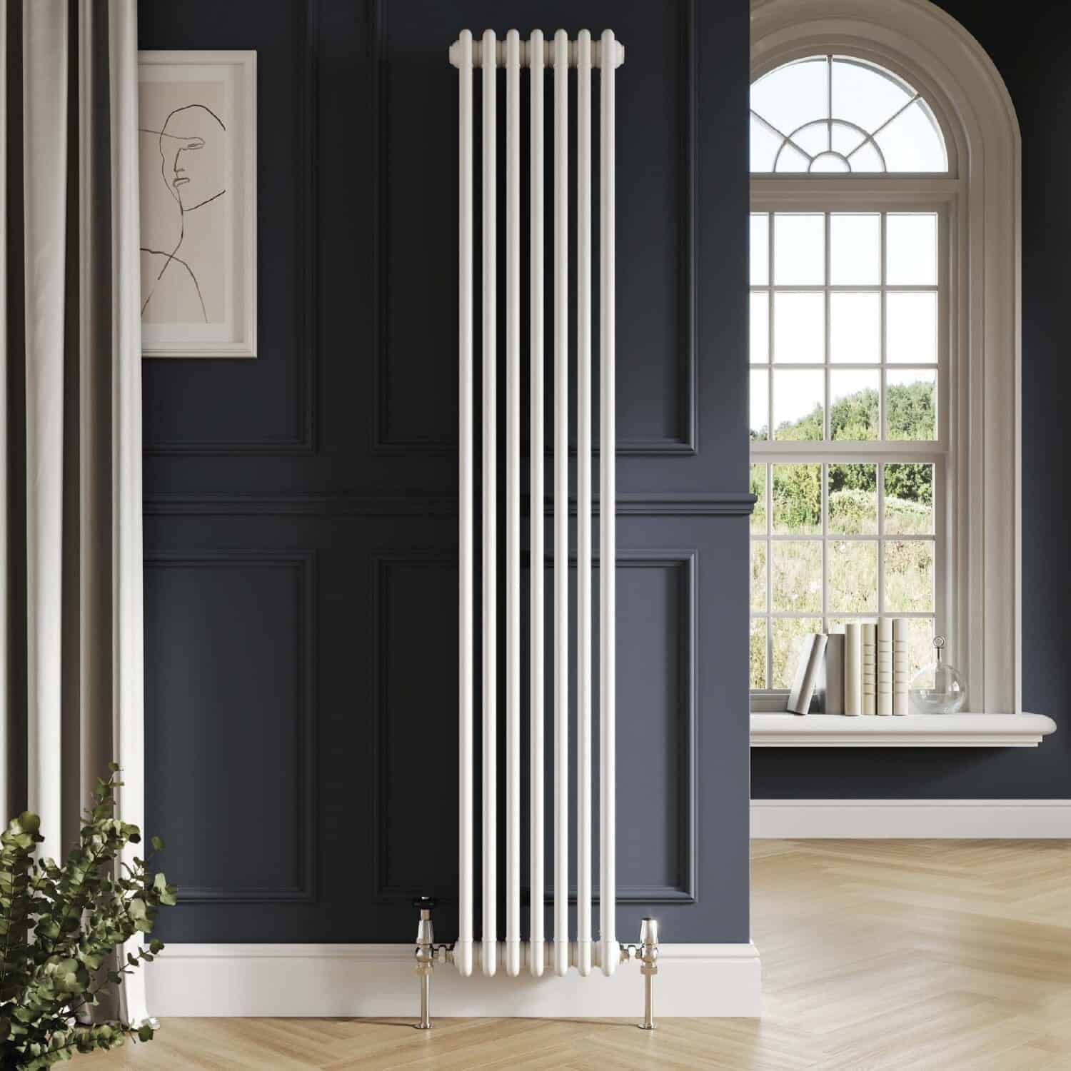 Modern white vertical radiator in a stylish navy blue bathroom with decorative wall mouldings and a large window with natural light.
