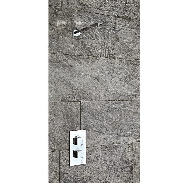 Shower head and control panel installed on a grey tiled bathroom wall, showcasing modern bathroom fixtures.