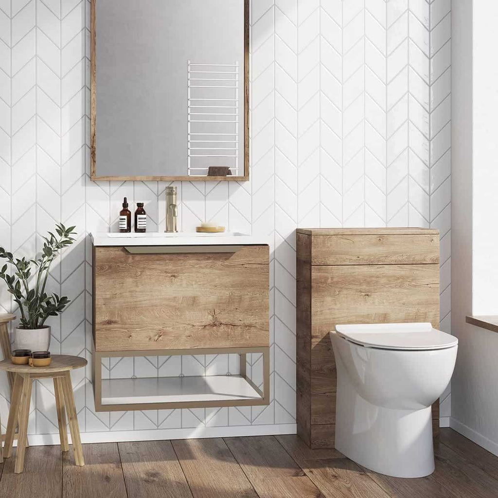 A minimalist bathroom with wooden vanity units, a large mirror, and a modern toilet, featuring white geometric wall tiles and wooden flooring for a contemporary, natural look.