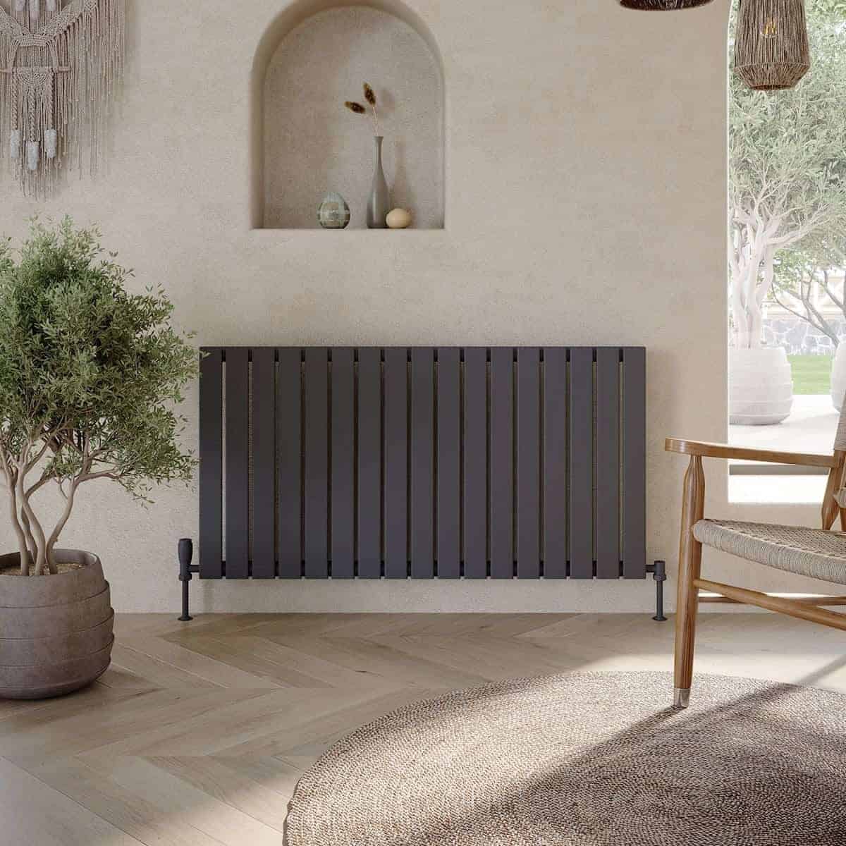 Stylish black radiator in a modern bathroom with minimalist decor, surrounded by natural elements and soft lighting, creating a contemporary and cosy atmosphere.