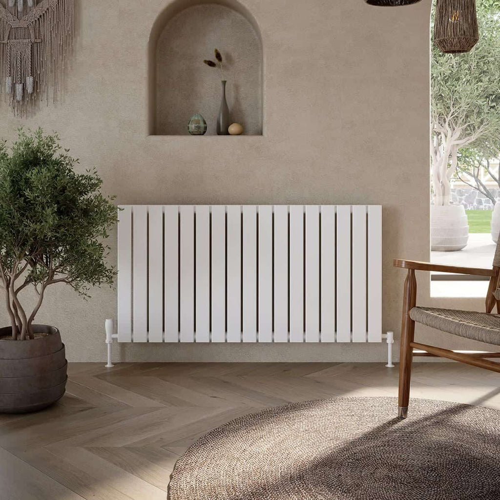 Clean modern bathroom radiator in a stylish neutral setting with decorative niche, potted plant, wooden chair, and natural light, ideal for contemporary bathroom decor.