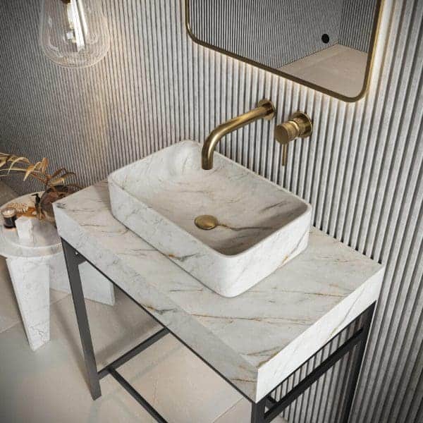Luxurious marble bathroom sink with gold fixtures on a modern vanity with a striped wall background, creating an elegant and stylish space for bathroom design and fixtures.