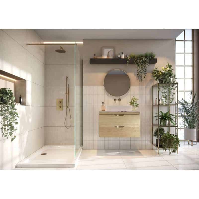 Modern bathroom with walk-in shower, wooden vanity, round mirror, and abundant indoor plants for a stylish and fresh design.