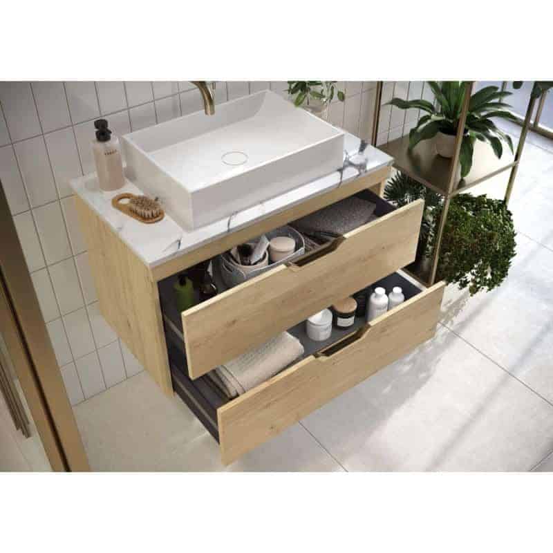 Modern wooden bathroom vanity with white vessel sink and marble countertop, featuring open drawers with towels, toiletries, and plants for stylish and functional bathroom storage.