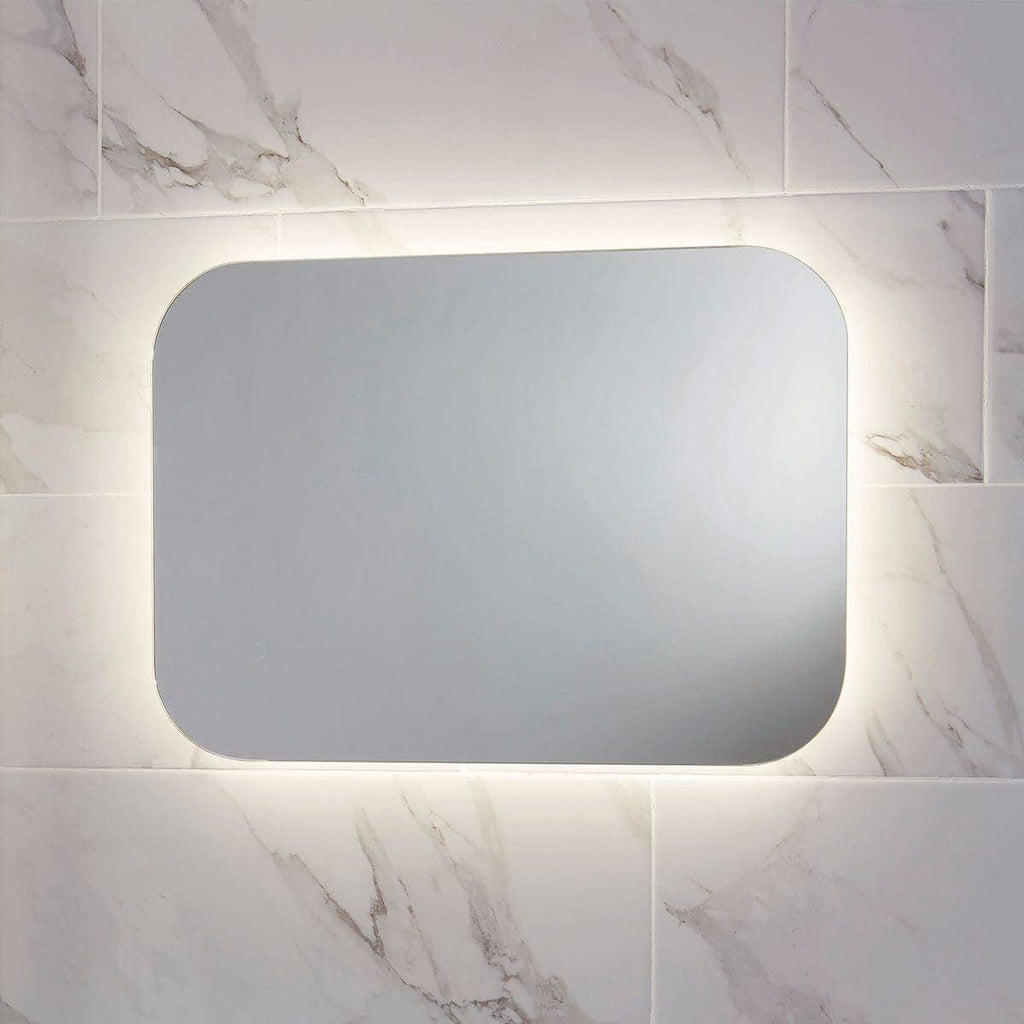 Sleek backlit LED bathroom mirror with rounded edges, mounted on marble-effect tiles, ideal for modern bathrooms. Designed for style and functionality in bathroom decor.