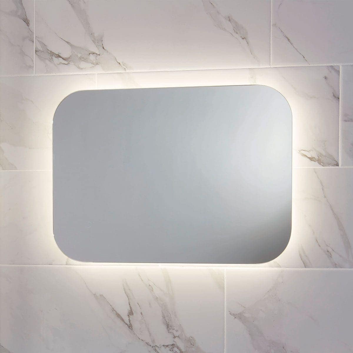 Sleek backlit LED bathroom mirror with rounded edges, mounted on marble-effect tiles, ideal for modern bathrooms. Designed for style and functionality in bathroom decor.