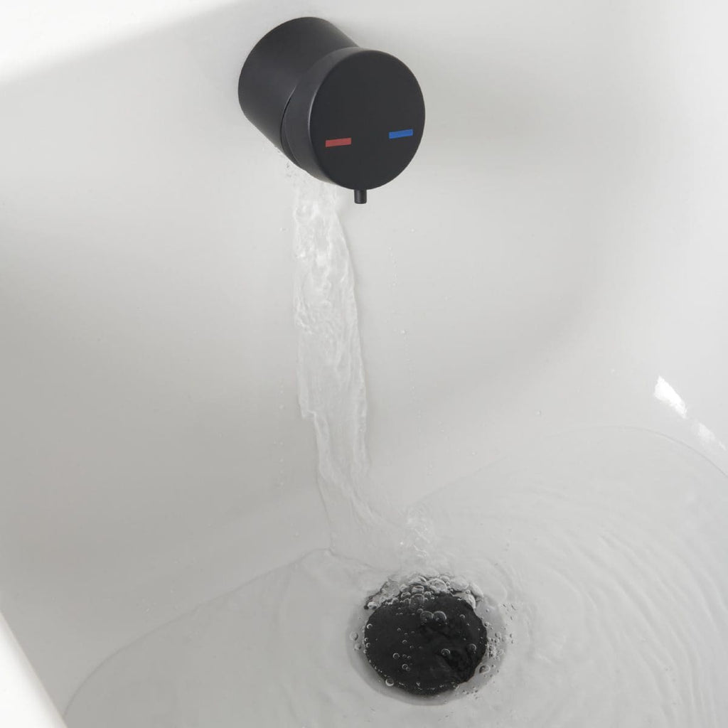 Flowing water from a black and blue thermostatic tap in a modern bathroom.