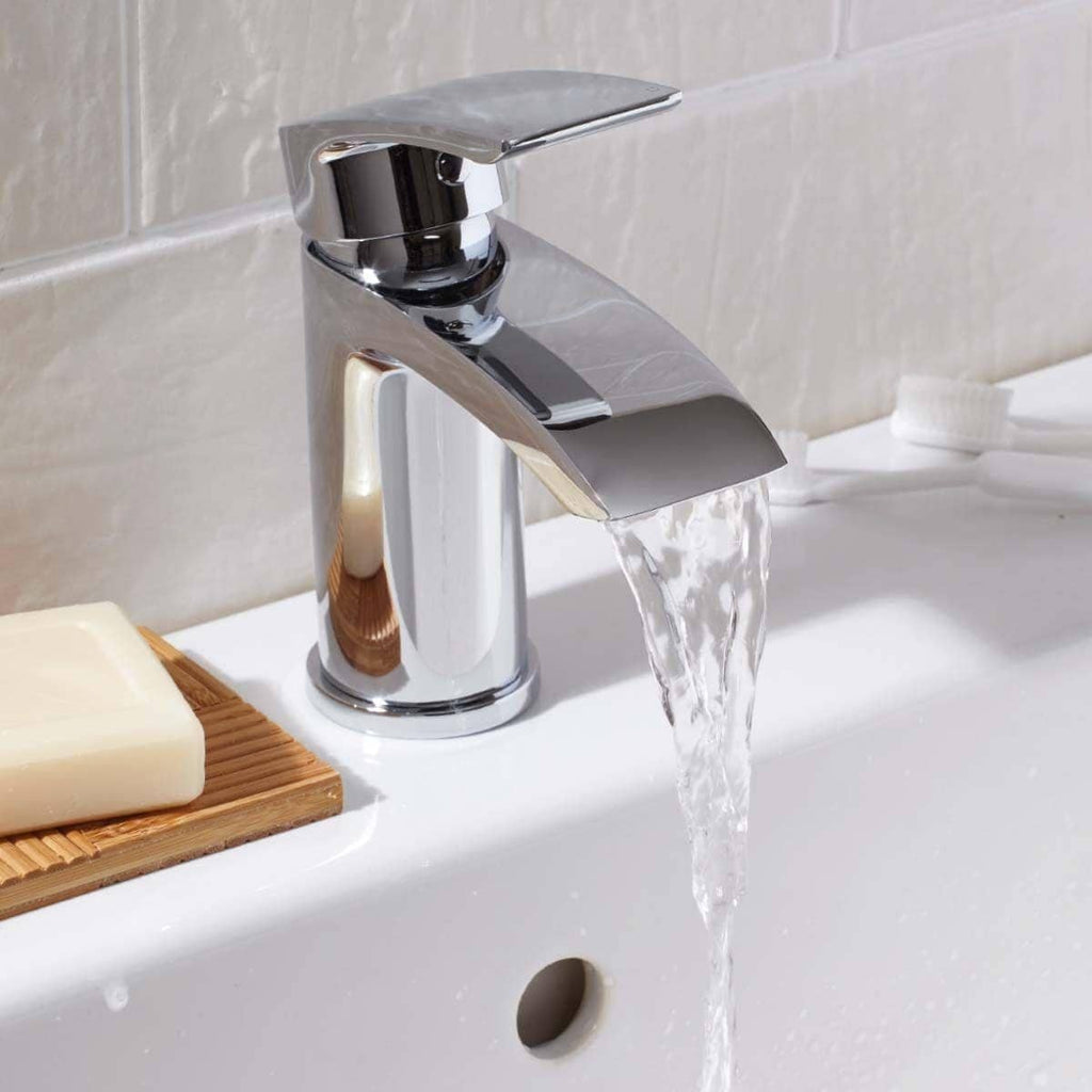 Sleek chrome bathroom tap with running water, modern design, installed on white basin in a contemporary bathroom setting.