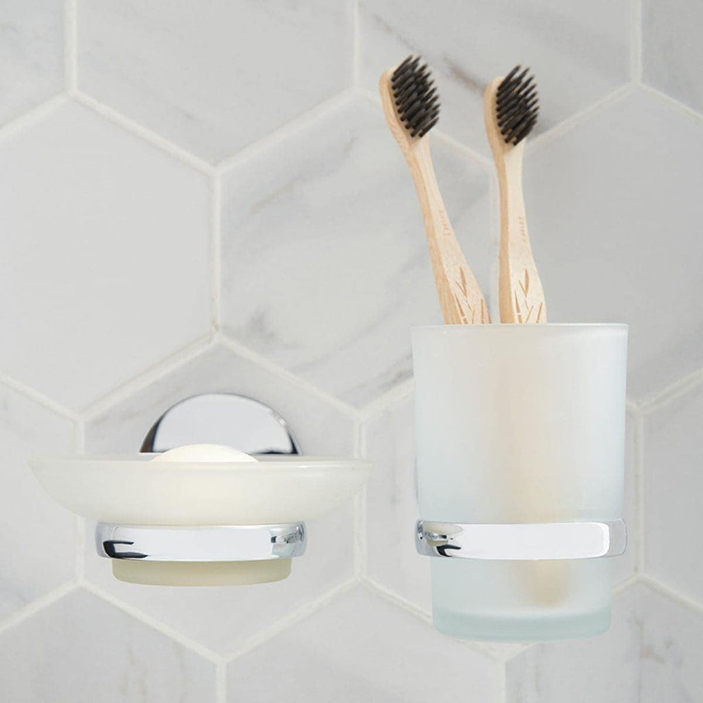Discreet bathroom toothbrush holder with two bamboo toothbrushes on white hexagon tile wall. Modern bathroom accessories by Bubly Bathrooms.