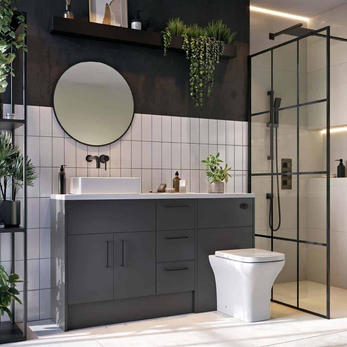 Modern grey bathroom vanity with white sink, black accents, and greenery decor, featuring a glass-enclosed shower and stylish black shelving for a sleek, contemporary bathroom design.