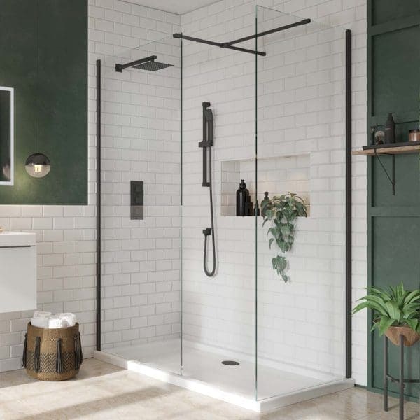 Elegant walk-in shower with black fixtures and white subway tiles, complemented by greenery and modern bathroom accessories. Perfect for contemporary Bubly Bathrooms designs.
