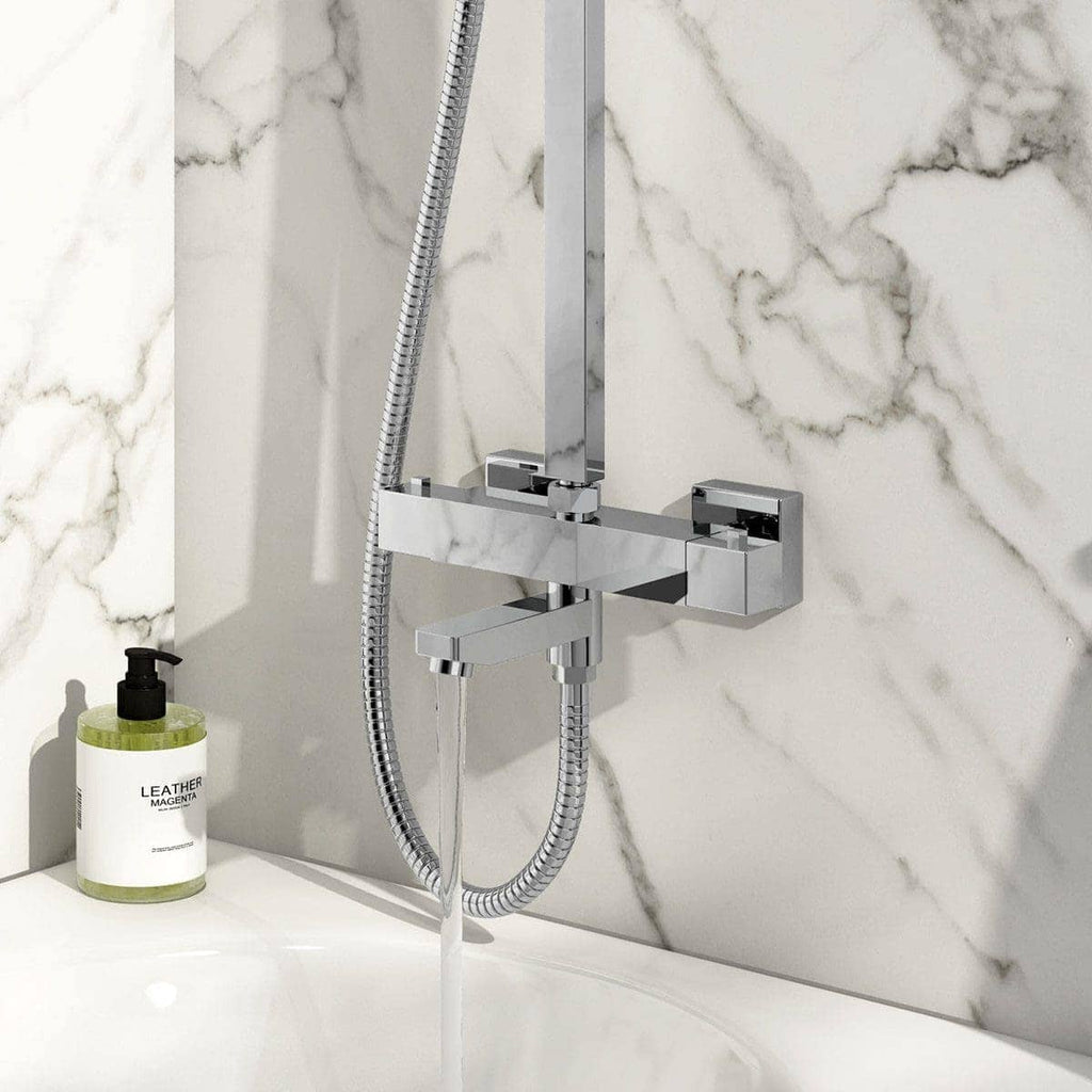 High-quality modern chrome bathroom shower mixer with handheld shower head mounted on a marble bathroom wall, featuring sleek design and elegant aesthetics.