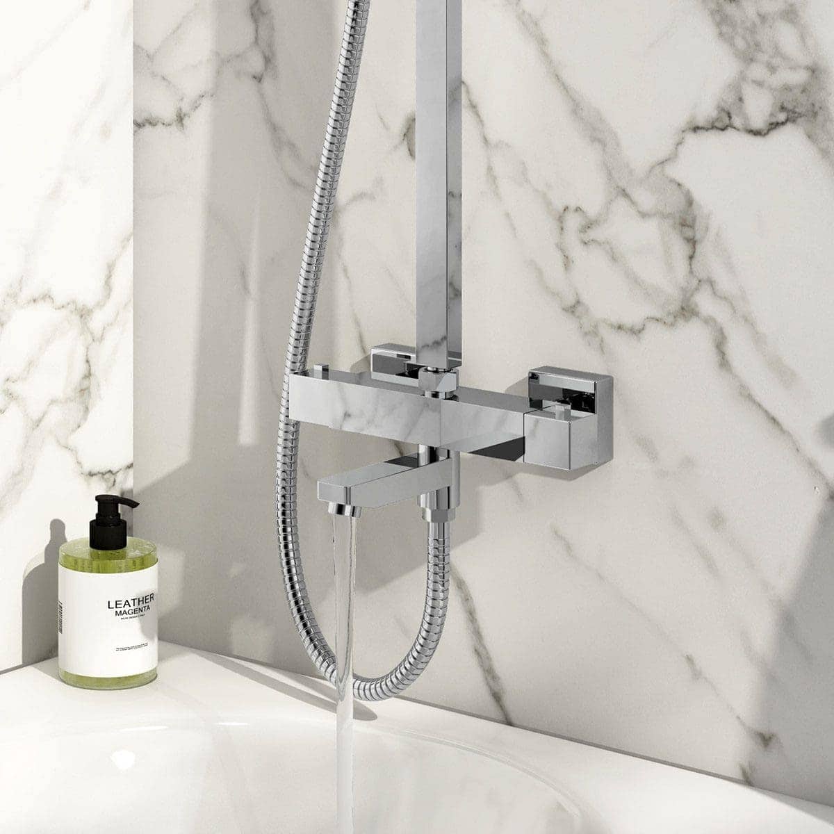 High-quality modern chrome bathroom shower mixer with handheld shower head mounted on a marble bathroom wall, featuring sleek design and elegant aesthetics.