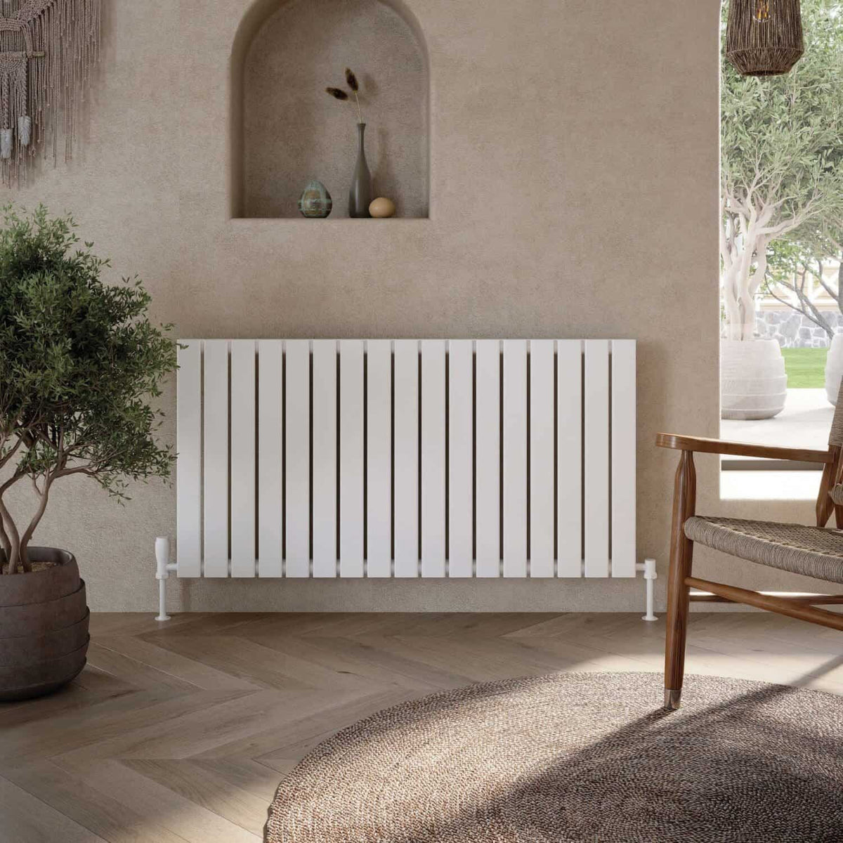 Sleek white wall-mounted radiator in a modern bathroom with natural decor elements and a wooden chair, featuring neutral tones and minimalist design for contemporary bathroom heating solutions.