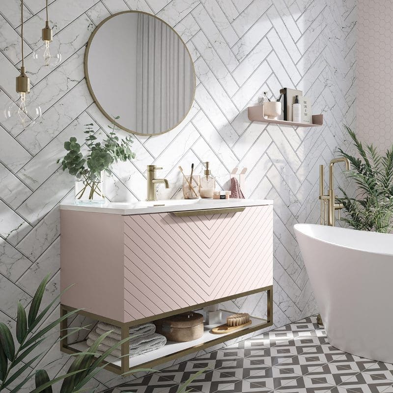 Elegant modern bathroom with pink vanity, gold fixtures, marble wall tiles, and a freestanding bathtub, showcasing luxurious Bubly Bathrooms interior design and contemporary style.