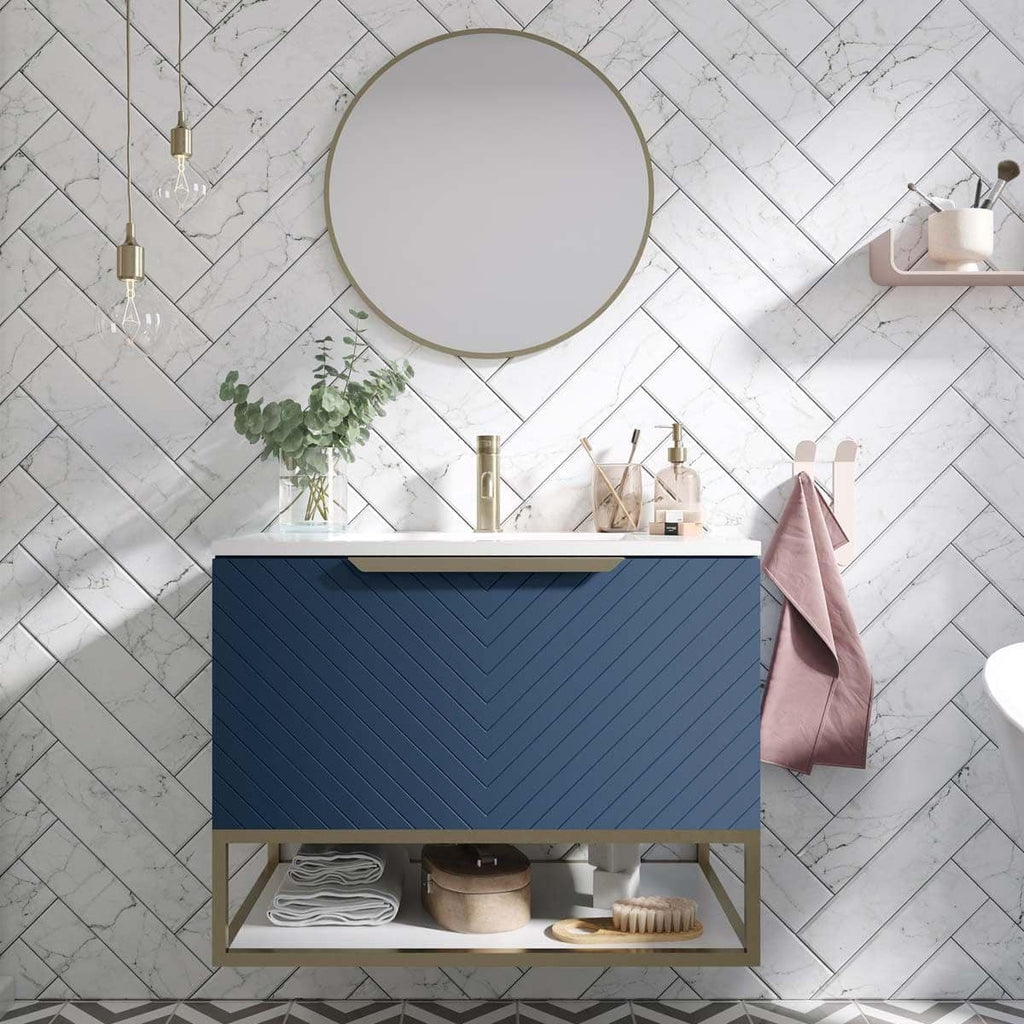 Contemporary blue bathroom vanity with marble countertop, round mirror, and modern accessories in a stylish bathroom setting.