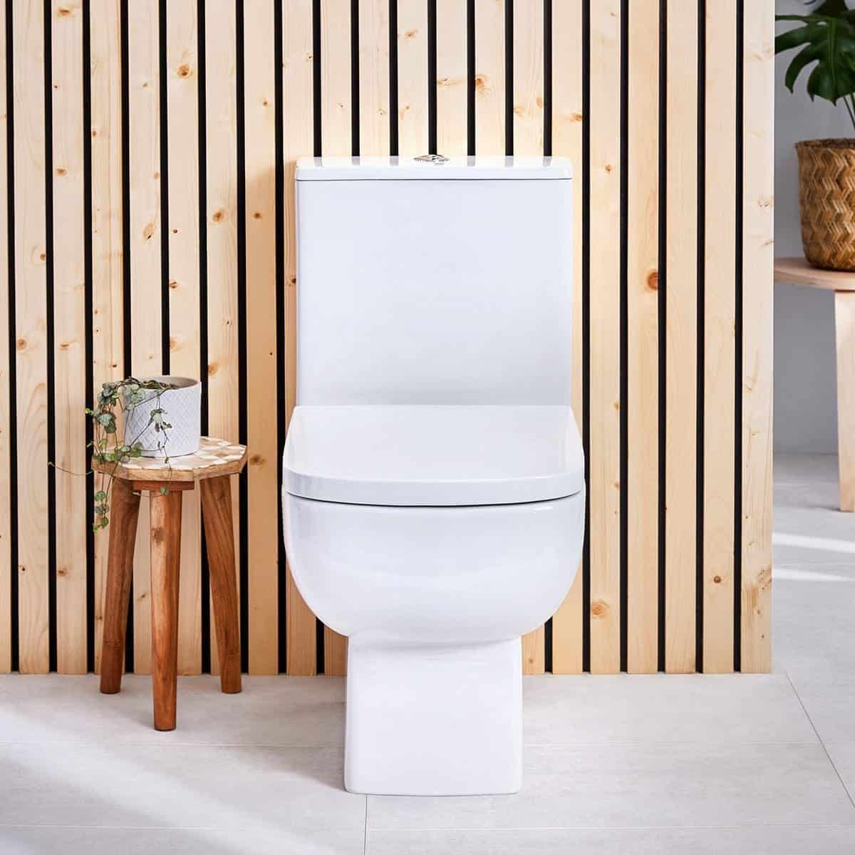 Contemporary white ceramic toilet with modern sleek design set against a natural wood panelled background, ideal for stylish bathroom renovations.