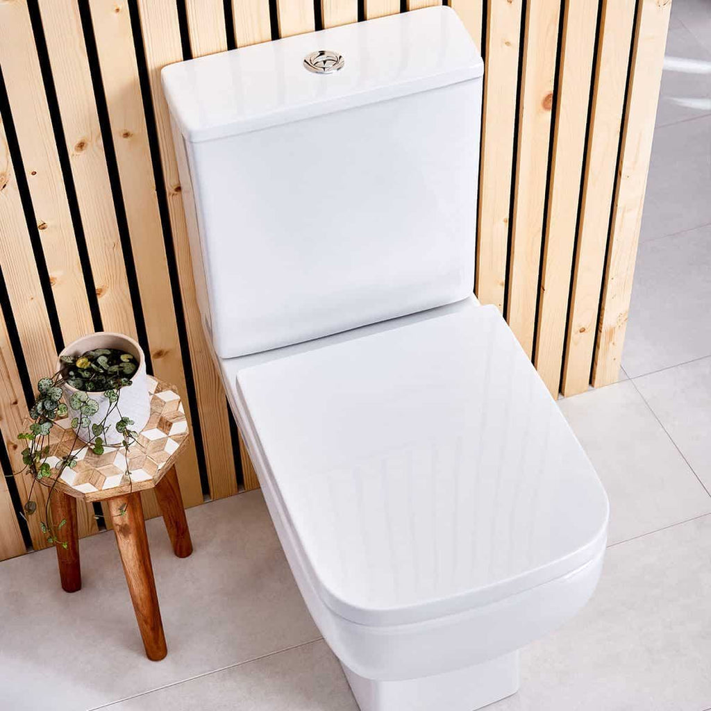 Toilet with modern design in a stylish bathroom setting, featuring wooden panel wall and decorative plant for a contemporary look. Ideal for bathrooms seeking a sleek, clean aesthetic.