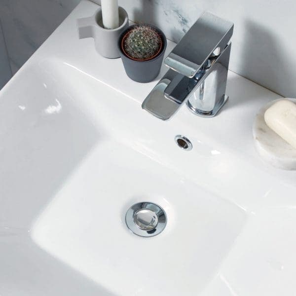 Sleek modern bathroom sink with chrome tap, white ceramic basin, and decorative plants, showcasing Bubly Bathrooms’ stylish bathroom fixtures and accessories.