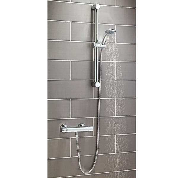 Chrome adjustable shower rail with handheld showerhead on grey tiled bathroom wall, modern and functional bathroom fixture.