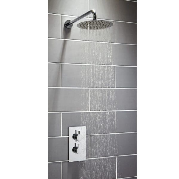 Shower head with rainfall feature in a modern grey tiled bathroom wall.
