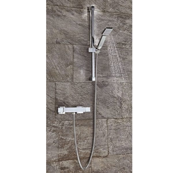 Modern chrome shower system with adjustable handheld showerhead and wall-mounted controls on a stone-effect tiled wall. Perfect for contemporary bathrooms and luxury shower upgrades.
