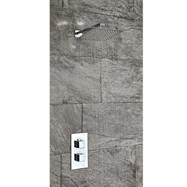 Sleek modern shower with rainfall head and digital control panel, set against textured grey stone tiles in a contemporary bathroom.