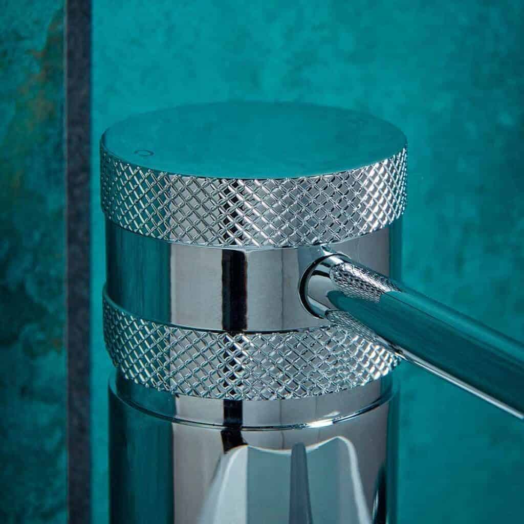 Shower drain cover with metallic finish and textured grip, designed for bathroom drainage systems. Ideal for modern bathroom renovations and plumbing efficiency.