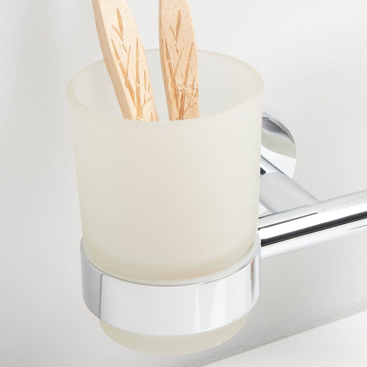 Vessel with wooden toothbrushes in a modern bathroom bathroom accessories and minimal decor.