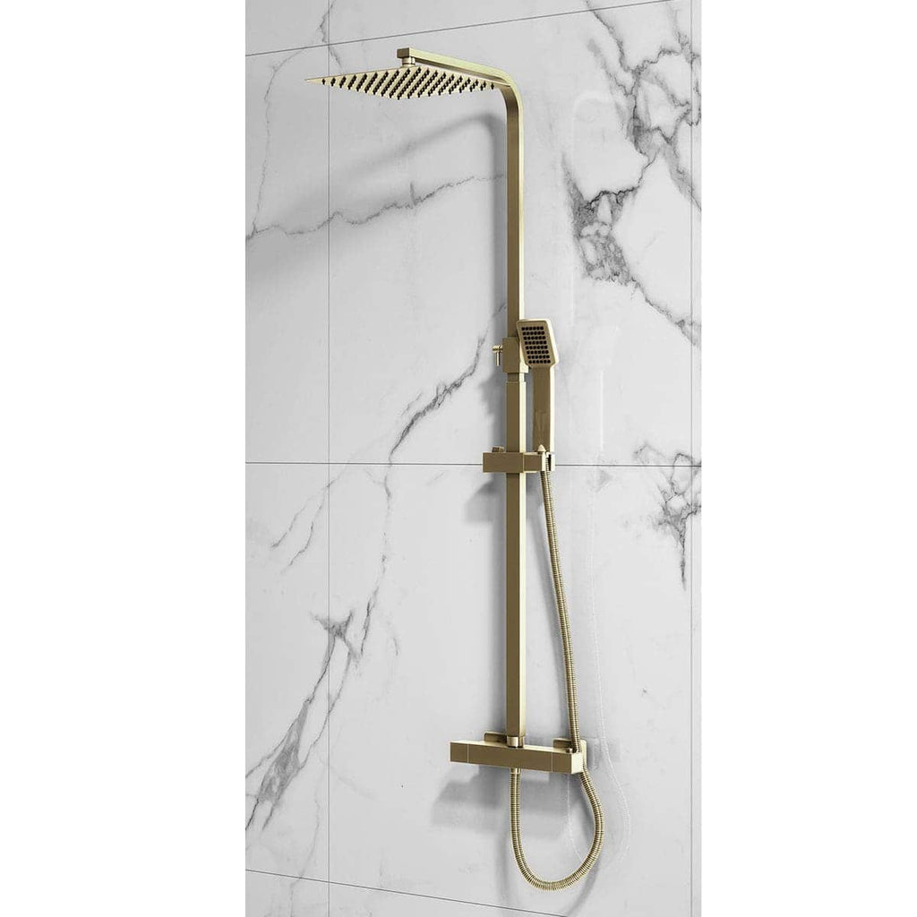 Brass modern shower system with overhead and handheld options installed on marble wall.
