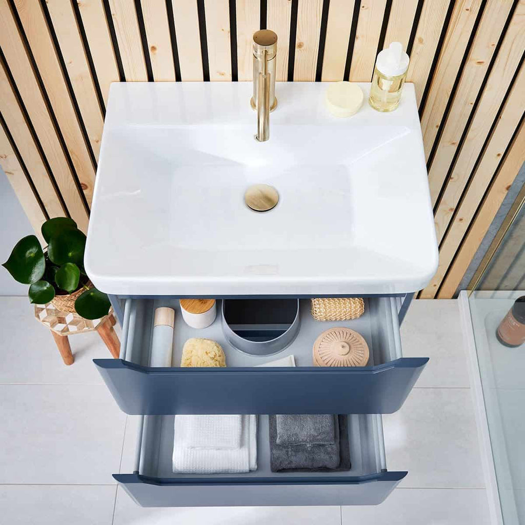 Luxurious modern white bathroom vanity with storage drawers and a sleek sink, ideal for contemporary bathrooms, featuring brass fixtures and natural wooden accents.