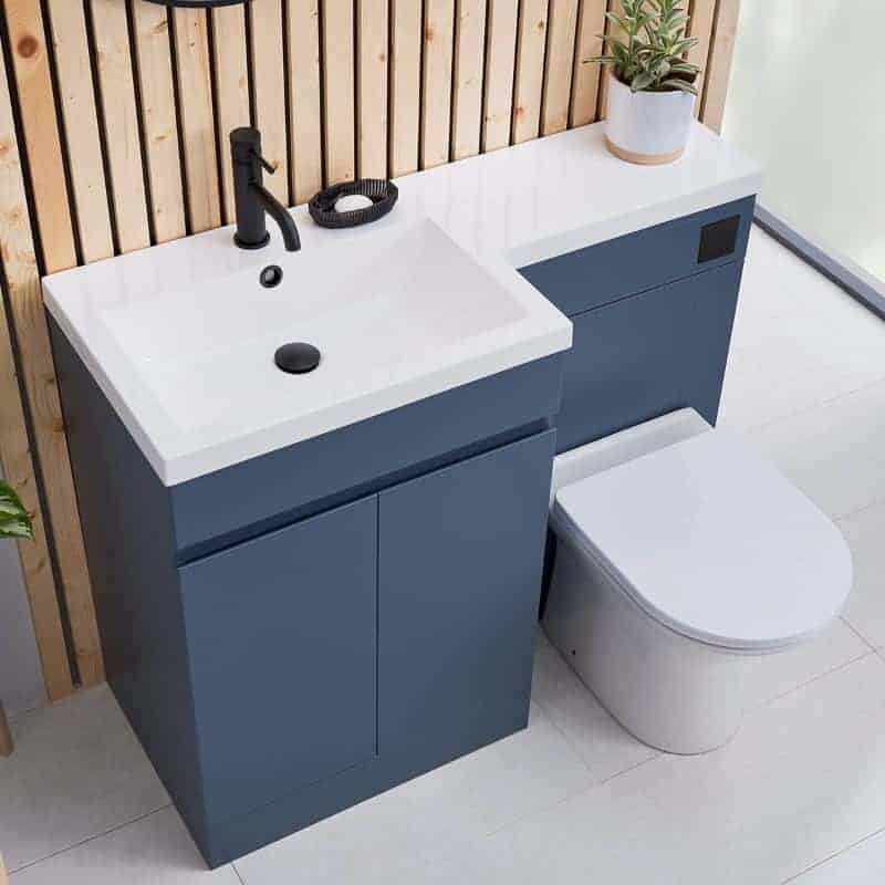 Modern blue bathroom vanity unit with integrated sink and black fixtures in a contemporary en suite bathroom.