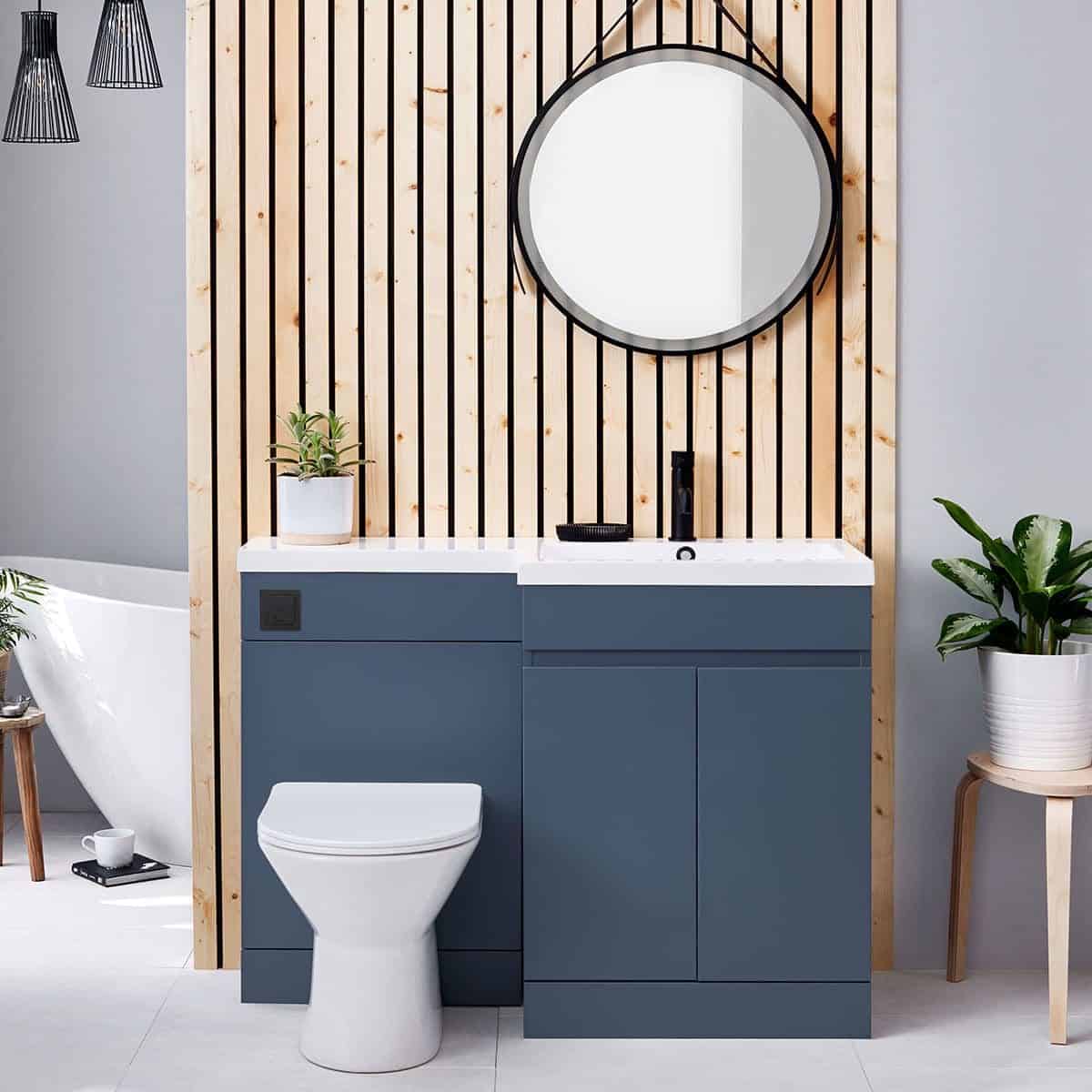 Contemporary bathroom vanity with blue cabinetry, round mirror, black fixtures, and wooden accents, creating a stylish and modern space for bathroom renovation.
