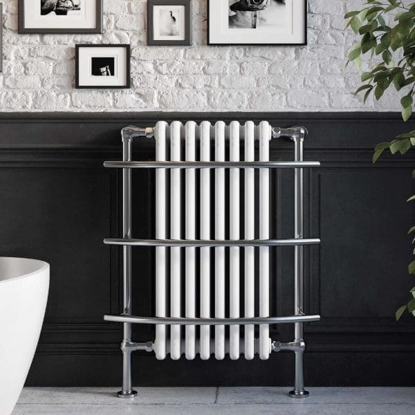 Radiator towel rail in a modern bathroom with black and white decor, featuring chrome finish pipes and a white radiator, perfect for bathroom heating and towel drying.