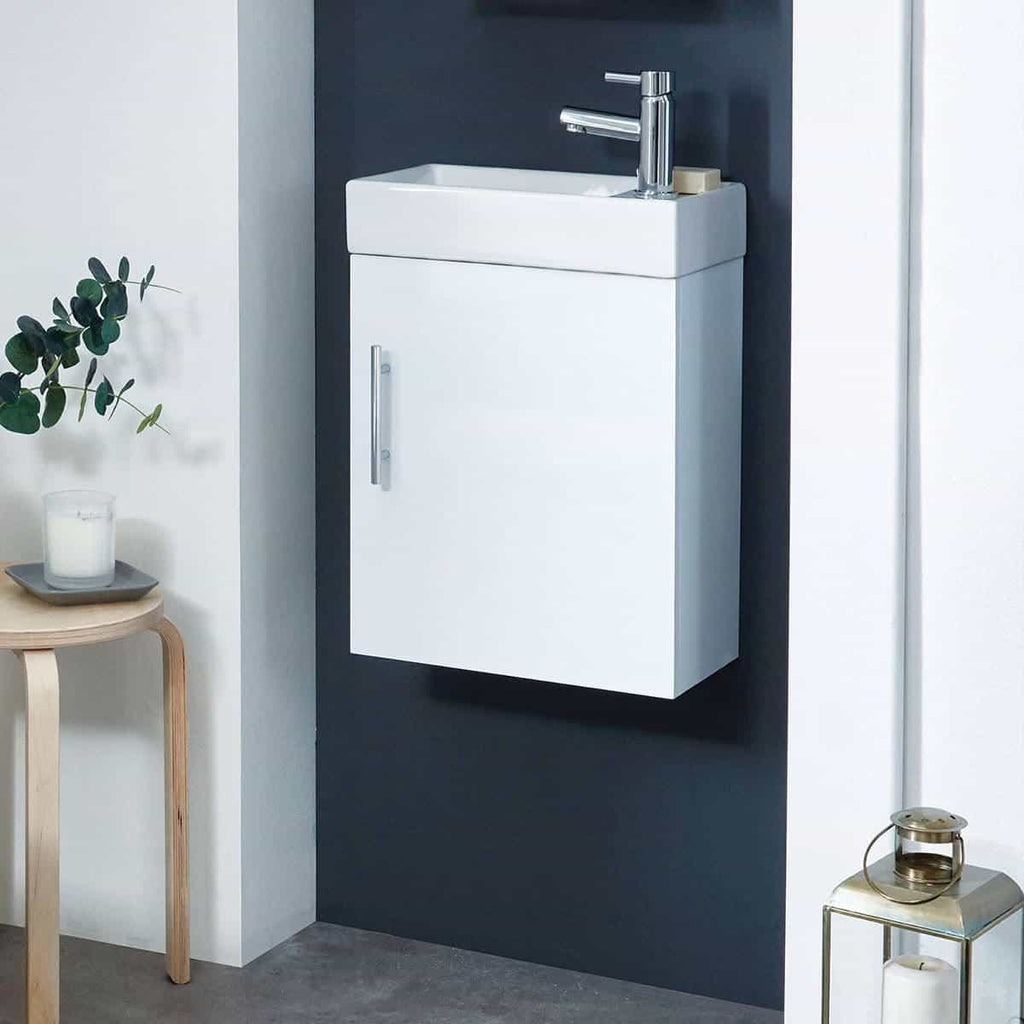Modern white bathroom vanity with integrated sink and chrome faucet, designed for compact spaces. Perfect for contemporary bathroom decor and efficient water usage.