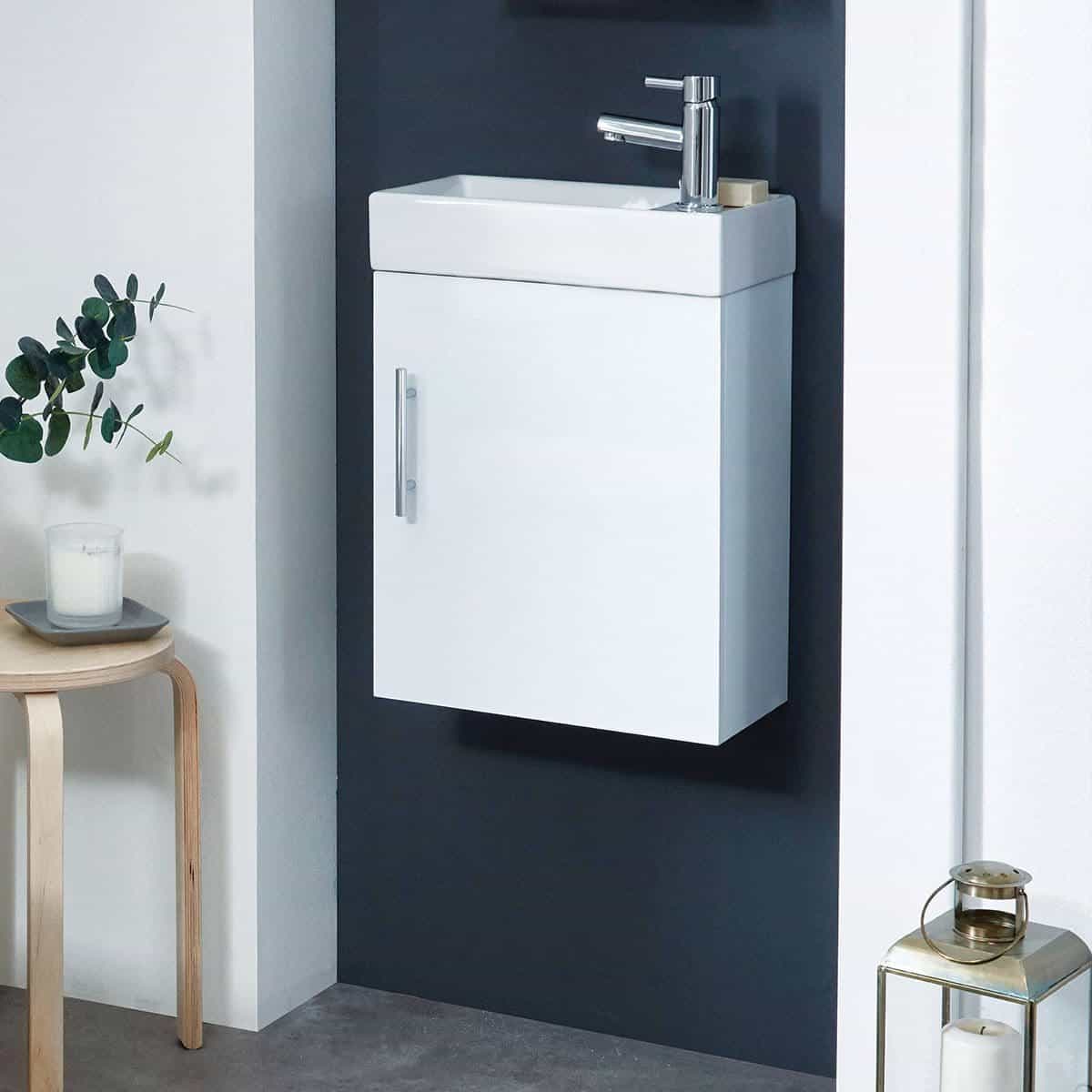 Modern white bathroom vanity with integrated sink and chrome faucet, designed for compact spaces. Perfect for contemporary bathroom decor and efficient water usage.
