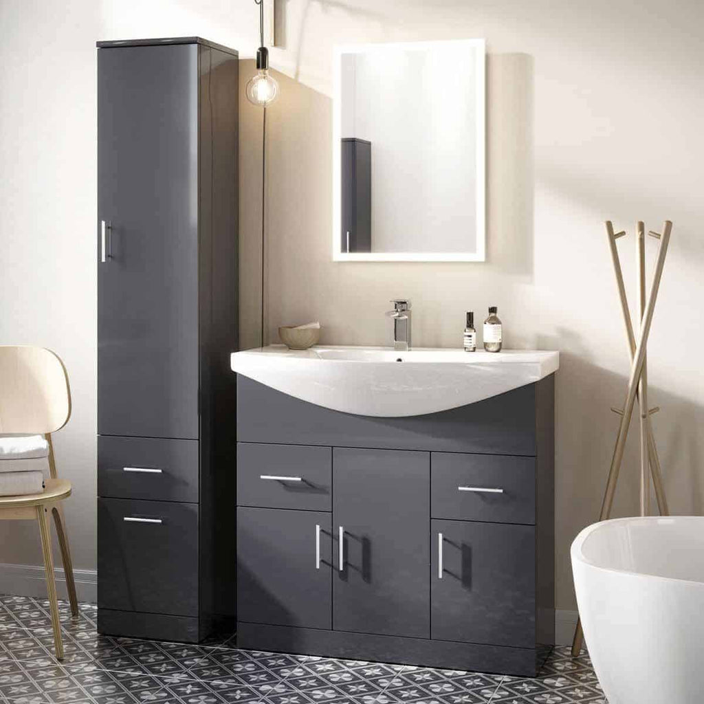 Sleek grey bathroom vanity with a modern design, featuring a white sink, illuminated mirror, and storage cabinets, complemented by a tall grey storage unit and minimalist decor.