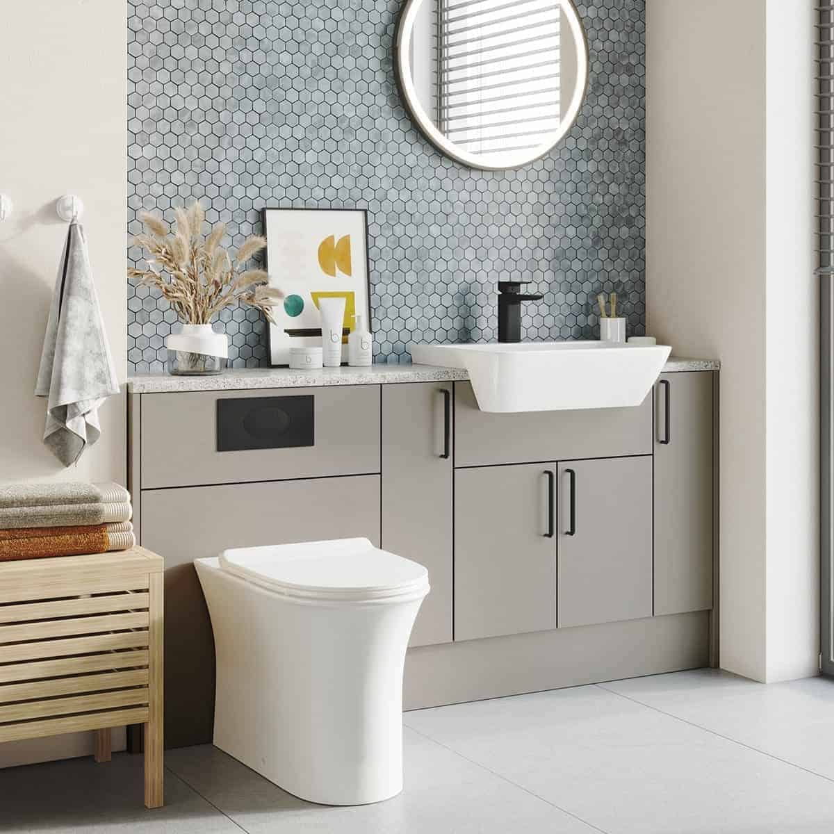 Contemporary grey bathroom vanity with integrated sink, black faucet, hexagonal tile backsplash, and minimalist decor in a modern bathroom setting.