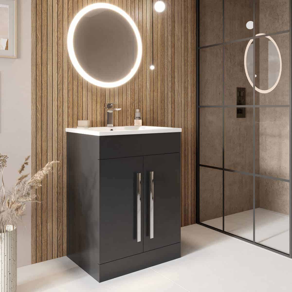 Sleek modern bathroom vanity with illuminated round mirror and walk-in shower featuring glass enclosure, wood paneling, and contemporary design elements for stylish Bubly Bathrooms.
