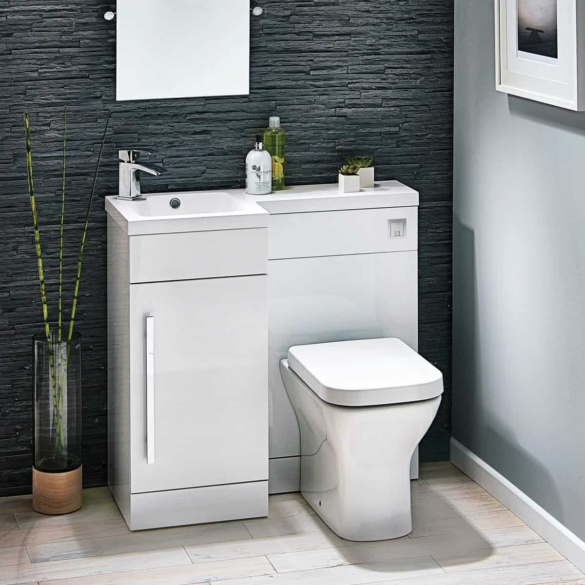 Sleek modern bathroom vanity unit with a built-in sink and toilet, featuring minimalist design and contemporary white finish. Perfect for stylish, functional bathroom spaces with black textured wall backdrop.