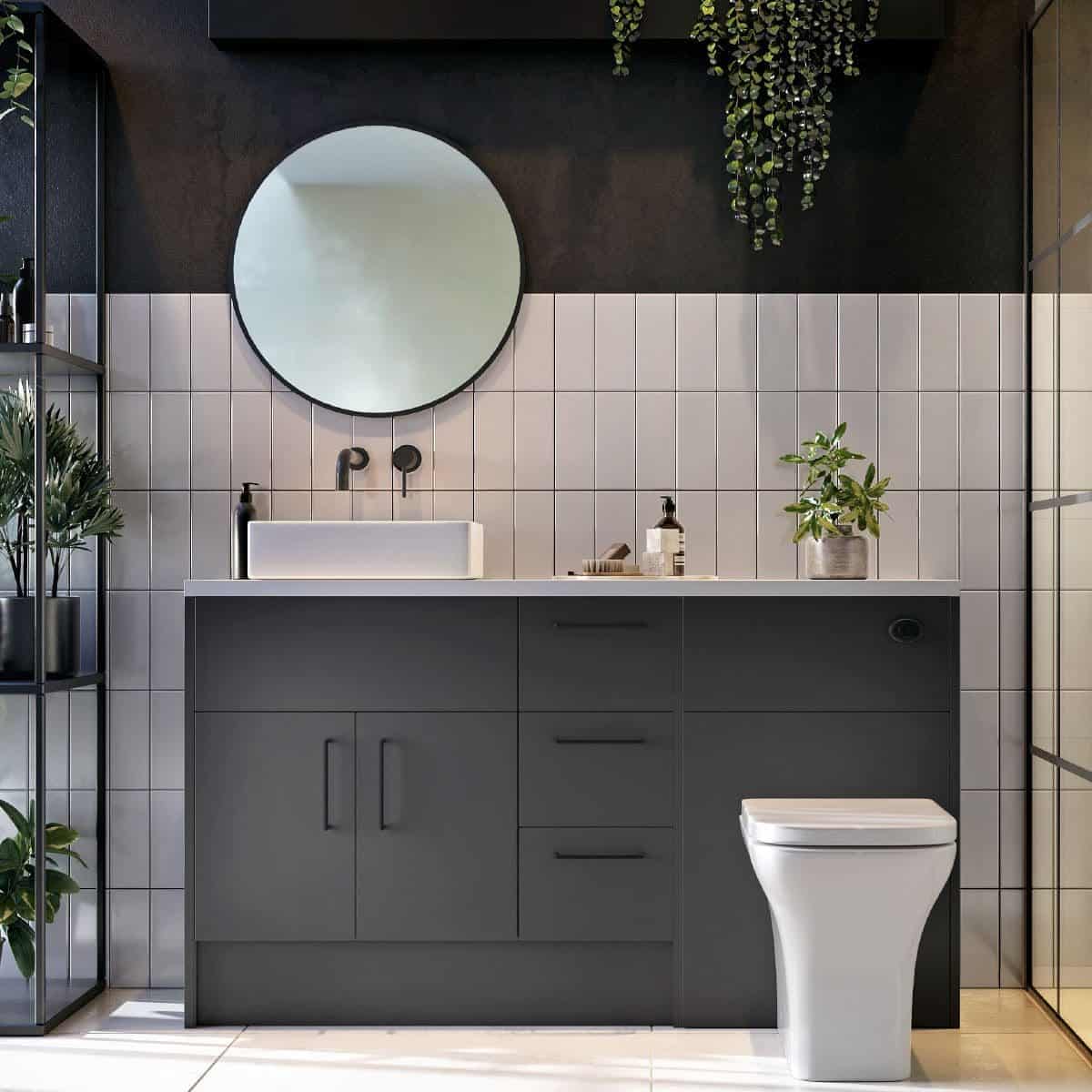 Contemporary bathroom featuring a sleek black vanity unit, modern vessel sink, round mirror, and potted plants for stylish bathroom decor and functionality.