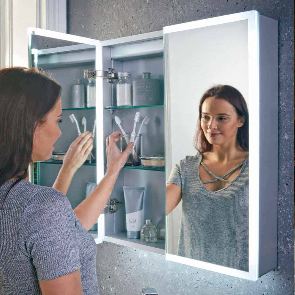 Shaving mirror with LED lighting in modern bathroom, featuring built-in storage for toiletries, ideal for personalised grooming and bathroom organisation.