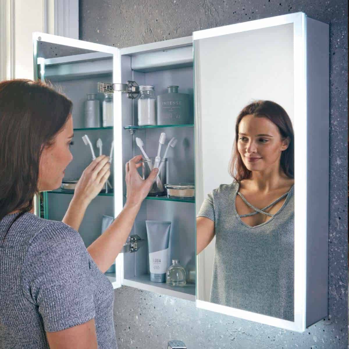 Shaving mirror with LED lighting in modern bathroom, featuring built-in storage for toiletries, ideal for personalised grooming and bathroom organisation.